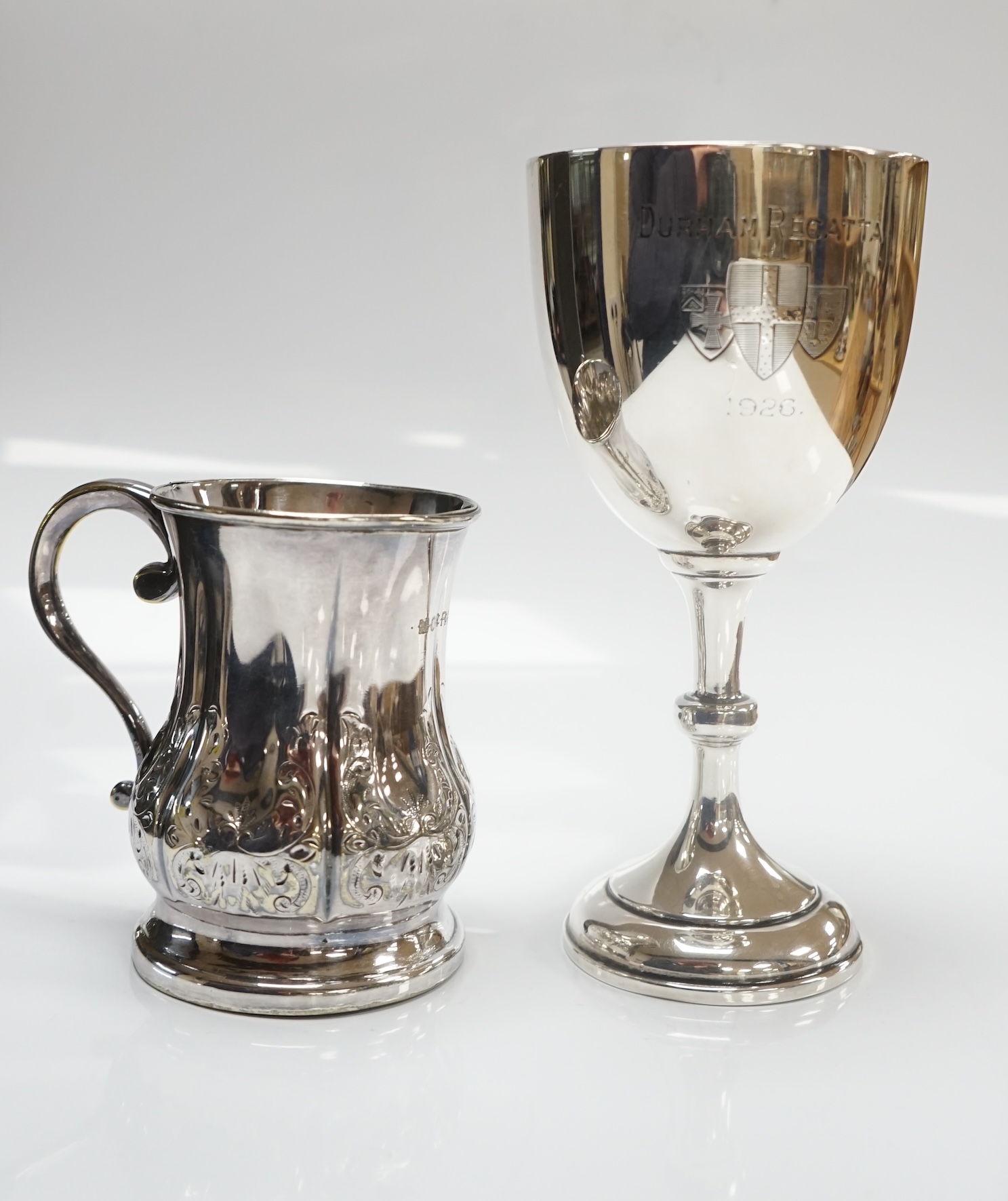 A George V silver goblet, Harrison & Sons, Birmingham, 1925, 15.3cm and a silver plated christening mug. Condition - fair